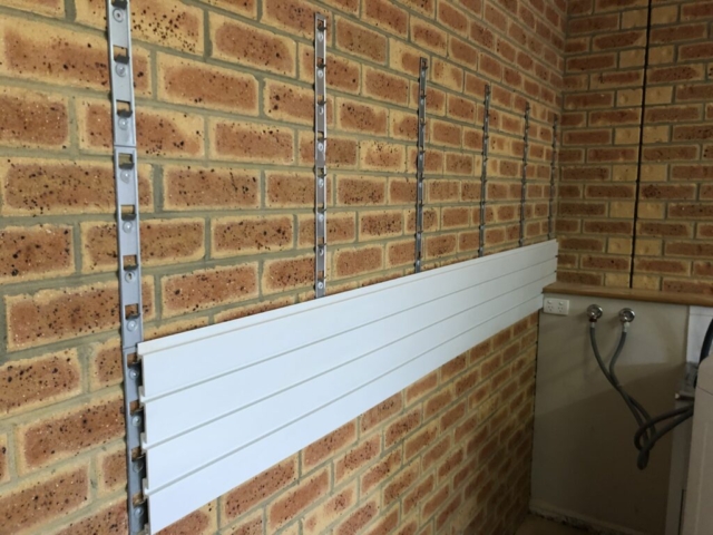 Installstrips on a Brick Wall