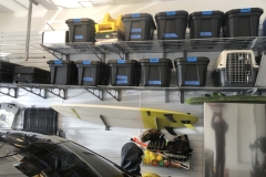 A shelving unit holding various stored household and garage items on StoreWALL panels
