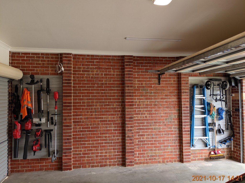 Barnwood Grey Wall Panels on a Brick Wall